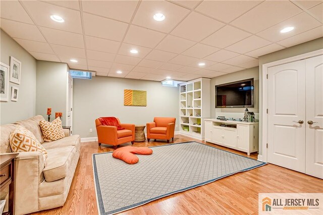 4 Van Gogh Ct, South Brunswick, NJ 08852 - living area featuring light wood-style floors, baseboards, a paneled ceiling, recessed lighting, and built in shelves