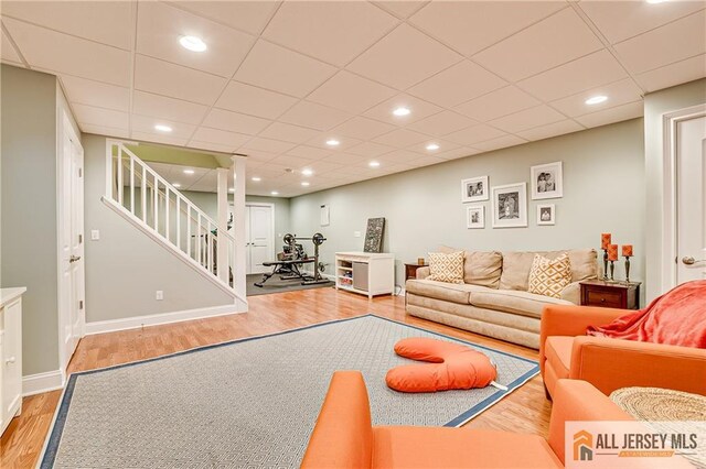 4 Van Gogh Ct, South Brunswick, NJ 08852 - living room with wood finished floors, a paneled ceiling, stairs, baseboards, and recessed lighting