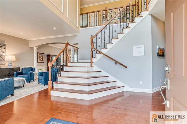 4 Van Gogh Ct, South Brunswick, NJ 08852 - stairway with ornamental molding, wood finished floors, decorative columns, arched walkways, and recessed lighting