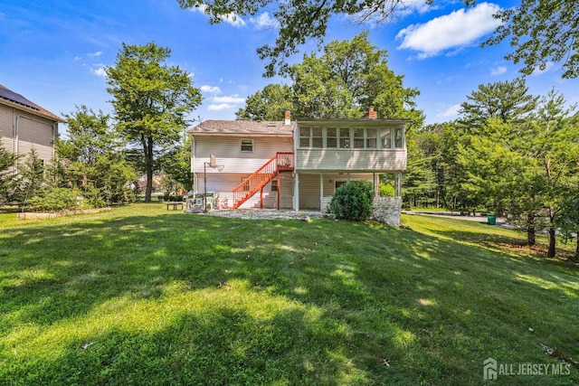 1099 New Dover Rd, Edison, NJ 08820 - back of property featuring a sunroom, stairs, a lawn, and a chimney
