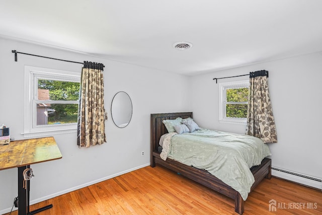 1099 New Dover Rd, Edison, NJ 08820 - bedroom with multiple windows, light wood-type flooring, and baseboard heating