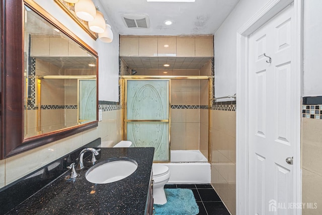 1099 New Dover Rd, Edison, NJ 08820 - bathroom with tile walls, tile patterned floors, vanity, bath / shower combo with glass door, and recessed lighting