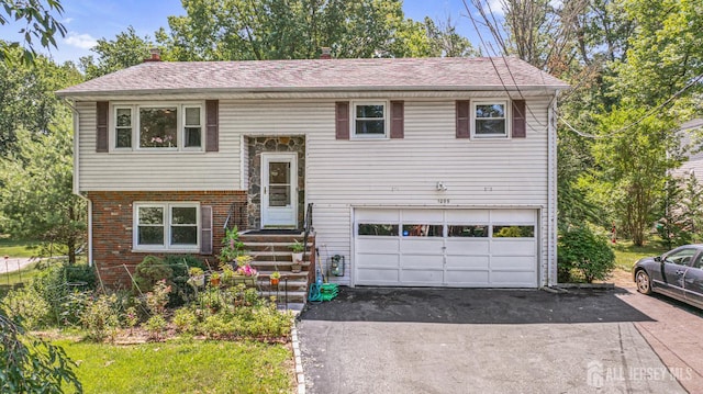 1099 New Dover Rd, Edison, NJ 08820 - bi-level home featuring a garage, driveway, a chimney, brick siding, and a shingled roof