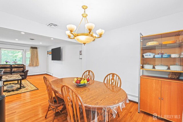 1099 New Dover Rd, Edison, NJ 08820 - dining space with a baseboard heating unit, a chandelier, light wood finished floors, a baseboard radiator, and recessed lighting