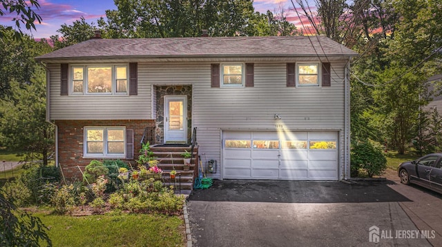 1099 New Dover Rd, Edison, NJ 08820 - bi-level home with a garage, asphalt driveway, and brick siding