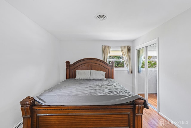 1099 New Dover Rd, Edison, NJ 08820 - bedroom with a baseboard heating unit and light wood-style flooring