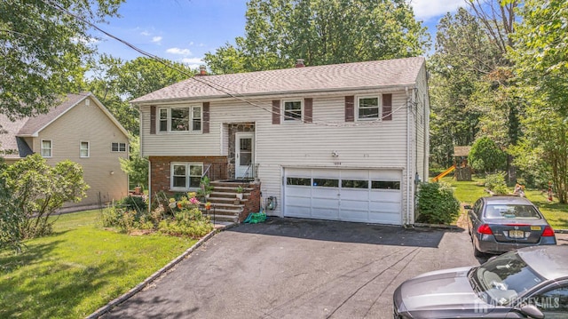 1099 New Dover Rd, Edison, NJ 08820 - raised ranch featuring an attached garage, asphalt driveway, a front lawn, and brick siding