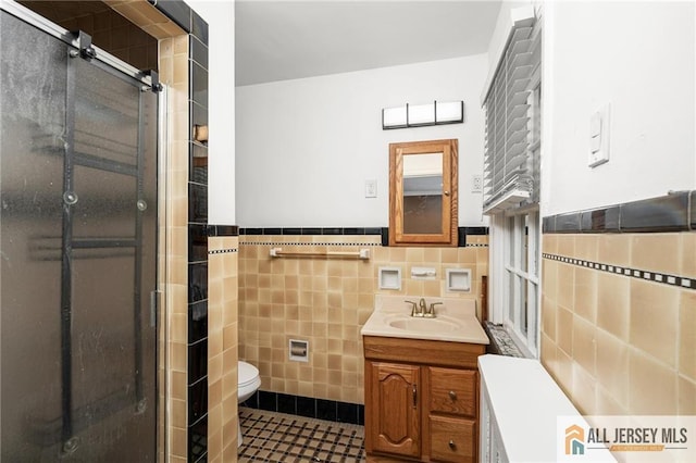 15 Kensington Ave, Trenton, NJ 08618 - bathroom featuring tile walls, vanity, a stall shower, tile patterned floors, and wainscoting