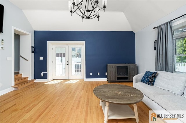 15 Kensington Ave, Trenton, NJ 08618 - living room with lofted ceiling, french doors, a chandelier, stairs, and light wood-style floors