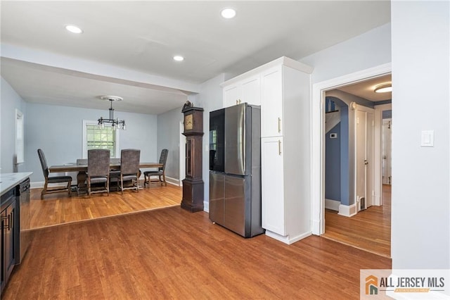 15 Kensington Ave, Trenton, NJ 08618 - kitchen featuring freestanding refrigerator, wood finished floors, white cabinetry, recessed lighting, and a chandelier