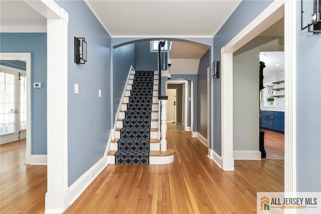 15 Kensington Ave, Trenton, NJ 08618 - entrance foyer with arched walkways, hardwood / wood-style floors, stairs, and crown molding