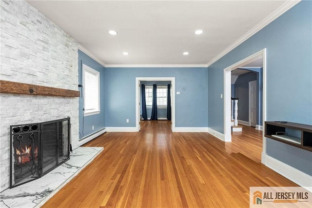 15 Kensington Ave, Trenton, NJ 08618 - unfurnished living room featuring wood finished floors, baseboard heating, ornamental molding, a stone fireplace, and recessed lighting