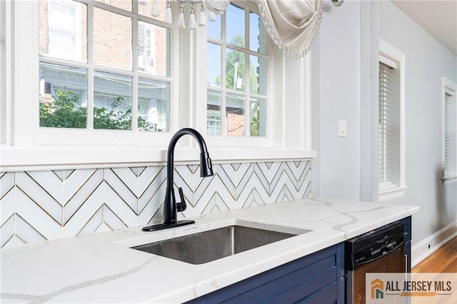 15 Kensington Ave, Trenton, NJ 08618 - kitchen with blue cabinetry, stainless steel dishwasher, light stone counters, and a chandelier