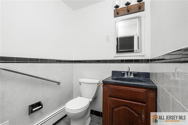 15 Kensington Ave, Trenton, NJ 08618 - bathroom with tile walls, baseboard heating, a wainscoted wall, and vanity