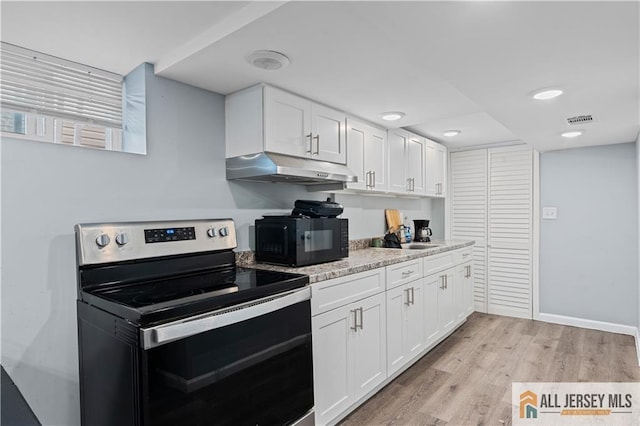 435 Ashley St, Perth Amboy, NJ 08861 - kitchen featuring electric stove, under cabinet range hood, black microwave, white cabinets, and recessed lighting
