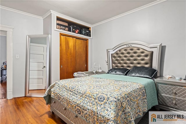 435 Ashley St, Perth Amboy, NJ 08861 - bedroom featuring crown molding, wood finished floors, and a closet