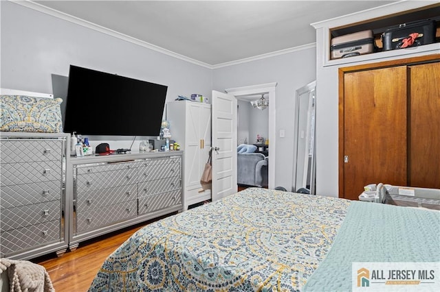 435 Ashley St, Perth Amboy, NJ 08861 - bedroom featuring crown molding, wood finished floors, and a chandelier
