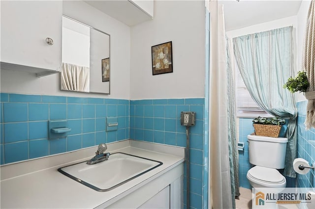 435 Ashley St, Perth Amboy, NJ 08861 - bathroom with tile walls, vanity, and a wainscoted wall