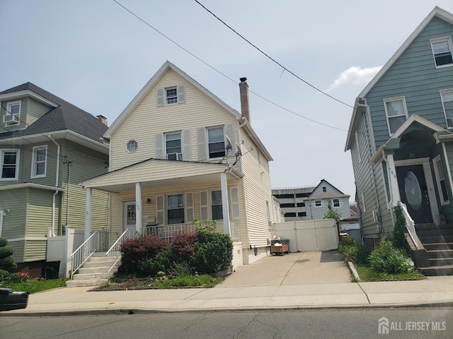 160 Pershing Ave, Carteret, NJ 07008 - view of front of property with a porch and a chimney