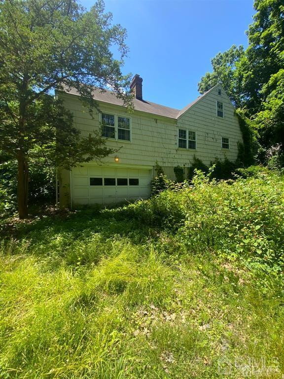 rear view of property with a garage