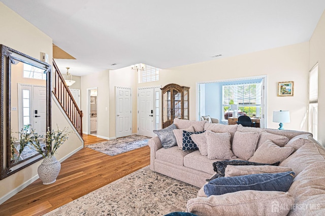3 Devon Ct, Monroe, NJ 08831 - living area with wood finished floors, stairway, baseboards, and a chandelier
