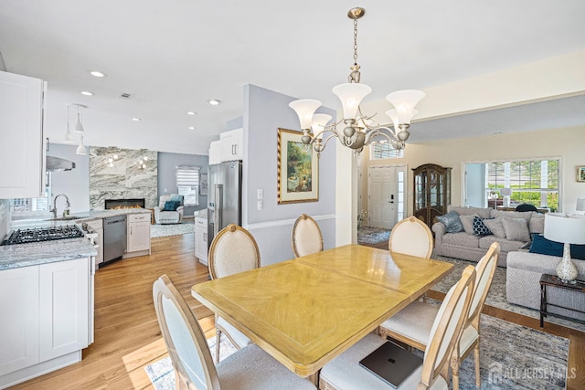 3 Devon Ct, Monroe, NJ 08831 - dining space with a chandelier, light wood finished floors, a high end fireplace, and recessed lighting