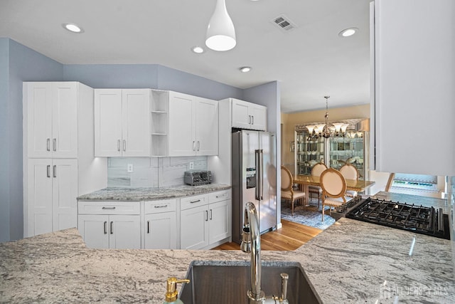 3 Devon Ct, Monroe, NJ 08831 - kitchen featuring stainless steel fridge, open shelves, a sink, tasteful backsplash, and gas stove
