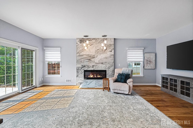 3 Devon Ct, Monroe, NJ 08831 - living area with plenty of natural light, a fireplace, and baseboards