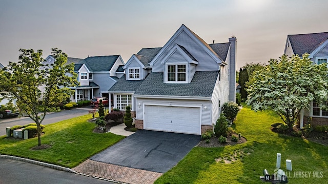 3 Devon Ct, Monroe, NJ 08831 - view of front of property with driveway, a chimney, a front lawn, and roof with shingles