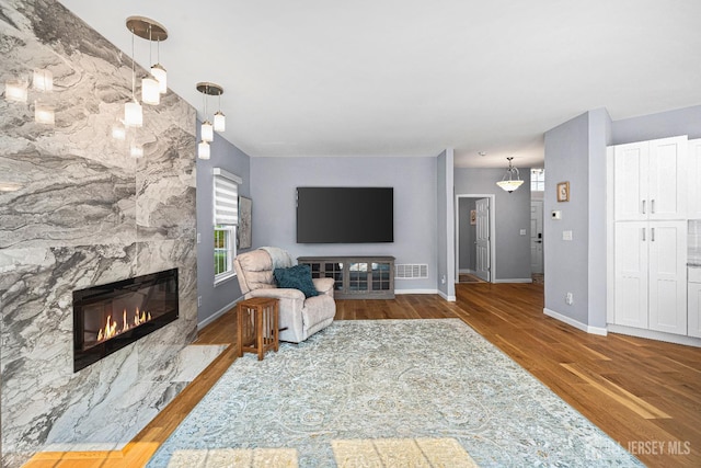 3 Devon Ct, Monroe, NJ 08831 - living area with a fireplace, wood finished floors, and baseboards