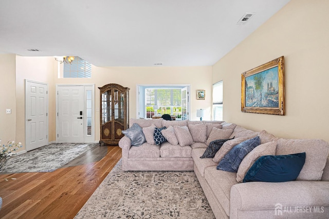3 Devon Ct, Monroe, NJ 08831 - living room featuring a chandelier, wood finished floors, and baseboards