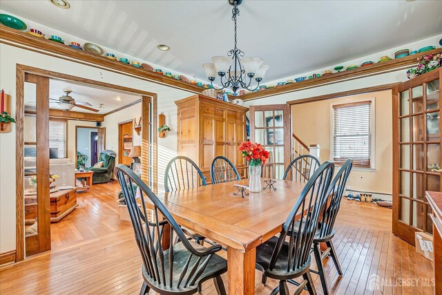 dining space featuring crown molding, ceiling fan with notable chandelier, and light hardwood / wood-style flooring