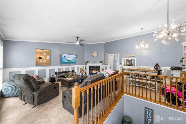 6 Amethyst Way, Franklin Twsp, NJ 08823 - living room with a chandelier, ornamental molding, carpet floors, ceiling fan, and a lit fireplace
