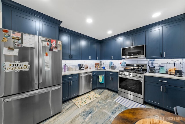 6 Amethyst Way, Franklin Twsp, NJ 08823 - kitchen with stainless steel appliances, blue cabinets, light countertops, decorative backsplash, and a sink