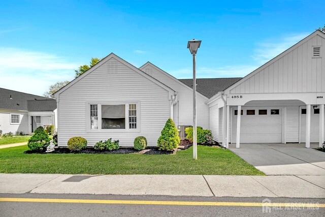 495 Newport Way Unit B, Monroe, NJ 08831 - view of front of home with a front yard, a garage, driveway, and board and batten siding