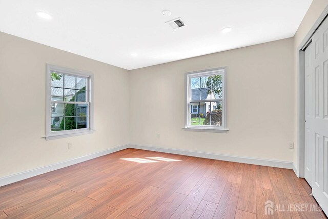 495 Newport Way Unit B, Monroe, NJ 08831 - unfurnished bedroom featuring multiple windows, light wood-type flooring, a closet, and recessed lighting