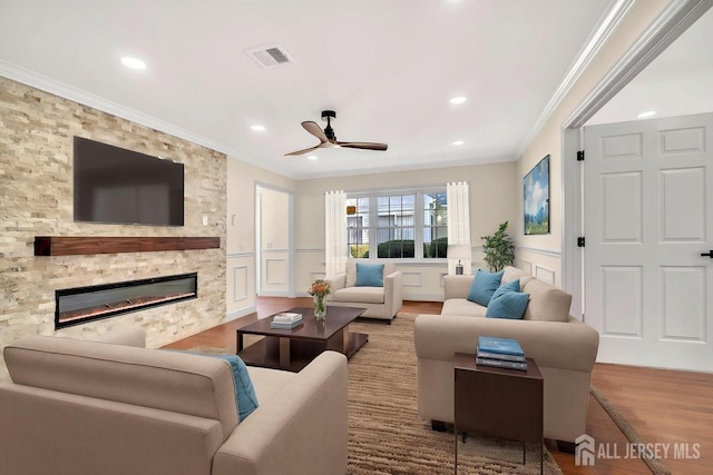 495 Newport Way Unit B, Monroe, NJ 08831 - living area featuring ornamental molding, a ceiling fan, a decorative wall, a stone fireplace, and wood finished floors
