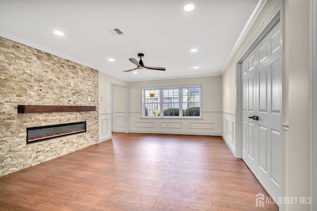 495 Newport Way Unit B, Monroe, NJ 08831 - unfurnished living room featuring visible vents, a decorative wall, crown molding, a fireplace, and ceiling fan