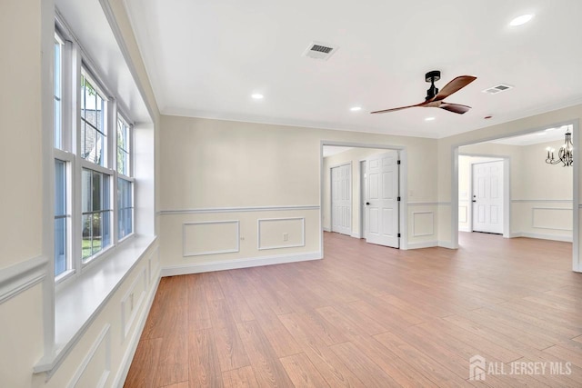 495 Newport Way Unit B, Monroe, NJ 08831 - unfurnished room featuring visible vents, ornamental molding, light wood-type flooring, a decorative wall, and ceiling fan with notable chandelier