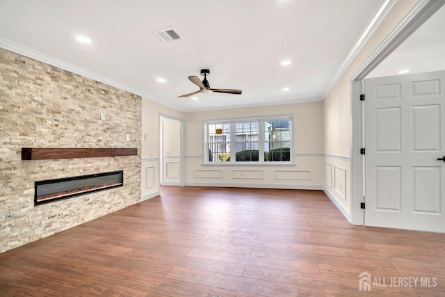 495 Newport Way Unit B, Monroe, NJ 08831 - unfurnished living room with crown molding, a ceiling fan, a decorative wall, wood finished floors, and a fireplace