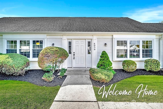 495 Newport Way Unit B, Monroe, NJ 08831 - view of exterior entry featuring a lawn and a shingled roof