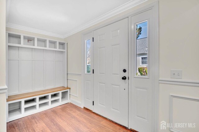 495 Newport Way Unit B, Monroe, NJ 08831 - mudroom featuring crown molding, light wood-type flooring, and a decorative wall