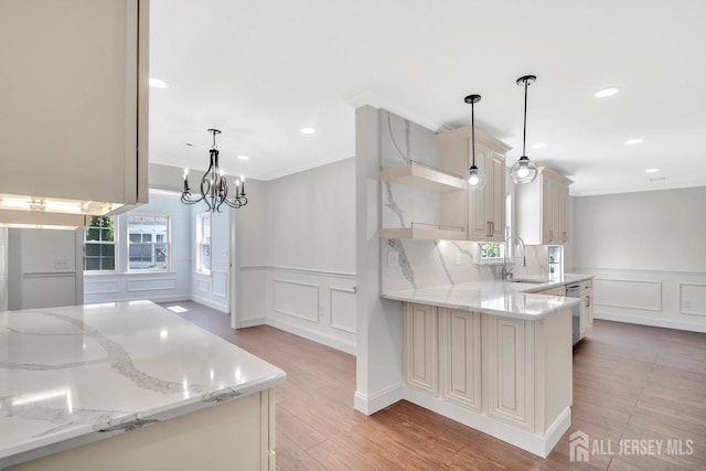 495 Newport Way Unit B, Monroe, NJ 08831 - kitchen with a chandelier, a decorative wall, light stone counters, and a sink