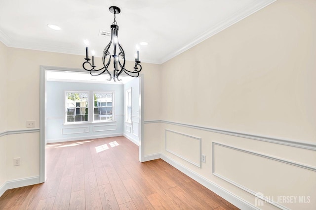 495 Newport Way Unit B, Monroe, NJ 08831 - unfurnished dining area with crown molding, visible vents, an inviting chandelier, wood finished floors, and a decorative wall