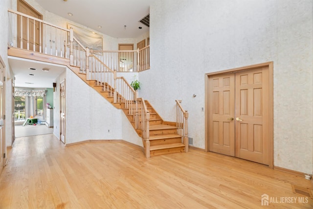 6 Allison Ct, Edison, NJ 08820 - foyer with a high ceiling, stairway, wood finished floors, and baseboards