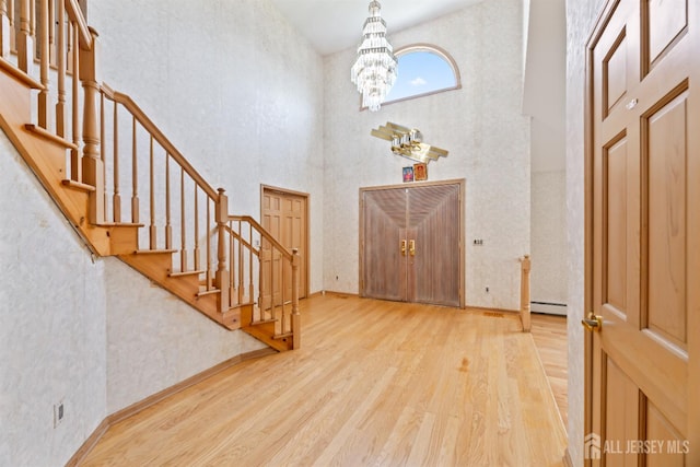6 Allison Ct, Edison, NJ 08820 - entrance foyer featuring wood finished floors, a towering ceiling, a chandelier, stairway, and a baseboard heating unit