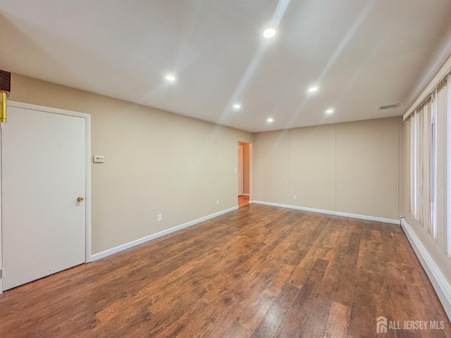 empty room with hardwood / wood-style floors