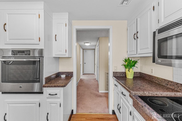 195 Mayflower Way Unit B, Monroe, NJ 08831 - kitchen featuring visible vents, white cabinets, dark countertops, and stainless steel appliances
