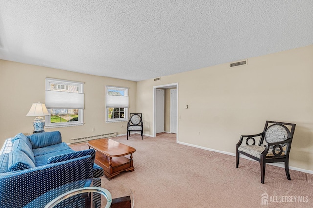 195 Mayflower Way Unit B, Monroe, NJ 08831 - carpeted living room featuring visible vents, baseboards, a textured ceiling, and a baseboard heating unit