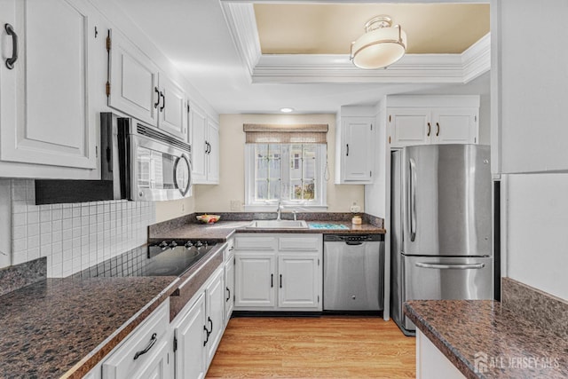 195 Mayflower Way Unit B, Monroe, NJ 08831 - kitchen featuring ornamental molding, dark countertops, a raised ceiling, a sink, and appliances with stainless steel finishes